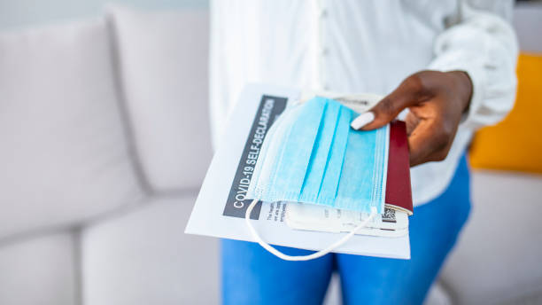 istock Young womans hand with passport,medical mask and negative rapid test 1385105465