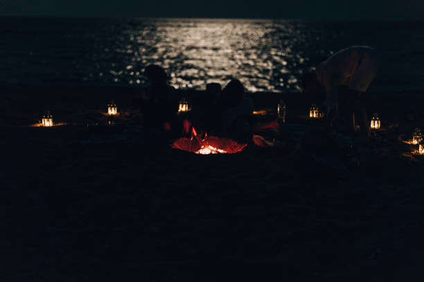 istock Friends having fun at the beach in the night 1385106308