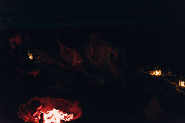istock Sausage on stick frying on camp fire. Grill weekend 1385106317