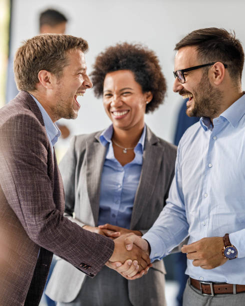 istock Cheerful businessmen greeting each other at corporate office. 1385106859