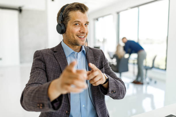 istock Happy businessman having a conference call in the office. 1385106951