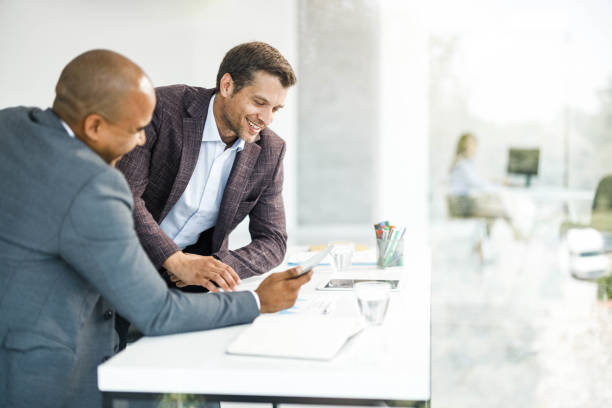 istock Happy businessmen working on touchpad in the office. 1385107174