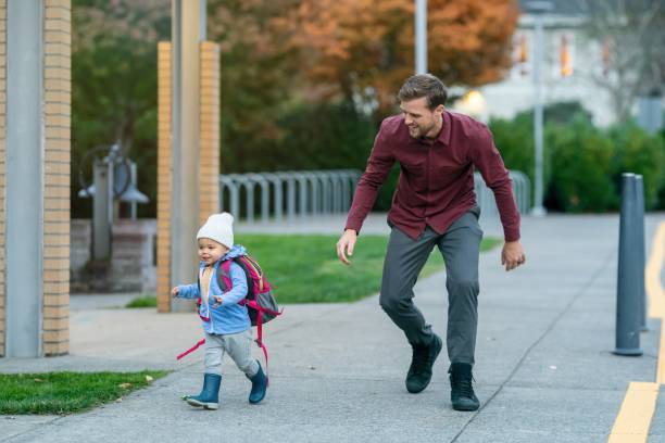 istock Playful little girl with dad after school 1385109568