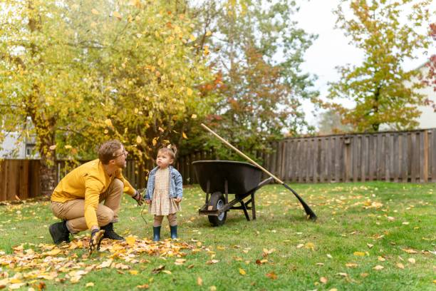 istock Playful dad having fun with daughter while working in the yard 1385109632