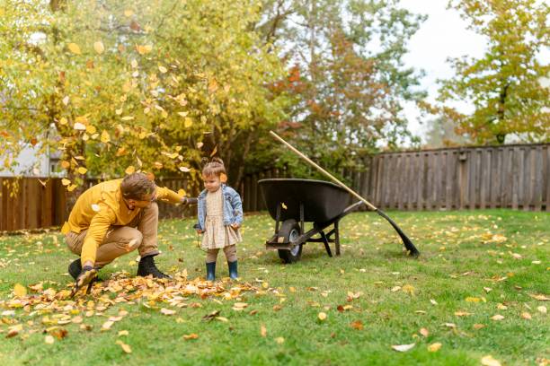 istock Playful dad having fun with daughter while working in the yard 1385109665