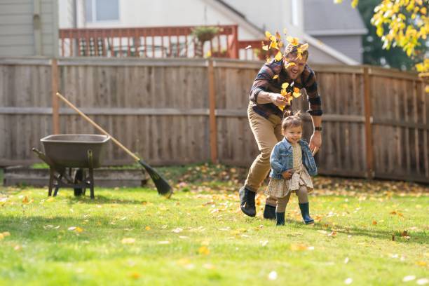 istock Loving dad playing in autumn leaves with daughter 1385109679