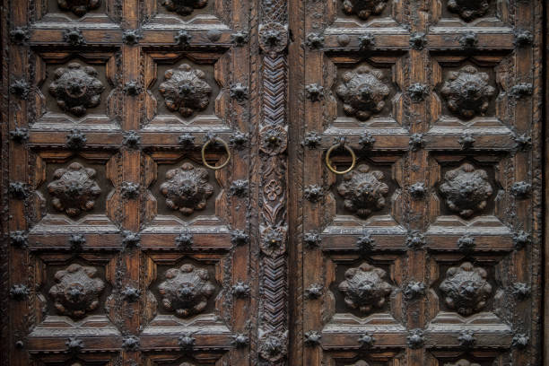 istock Old decorated wooden front door. 1385109871
