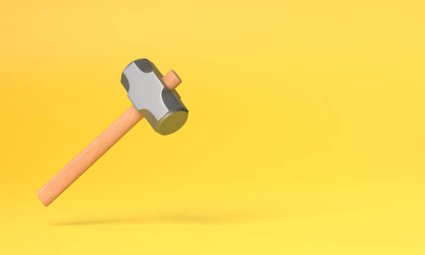 Flying hammer on yellow background with copy space