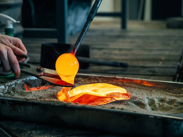 Melting glass mould into sand form Creating traditional glass Art. Glass melting in a traditional oven of a glassblower manufacture. Melting glass mould into sand form hand blown glass stock pictures, royalty-free photos & images