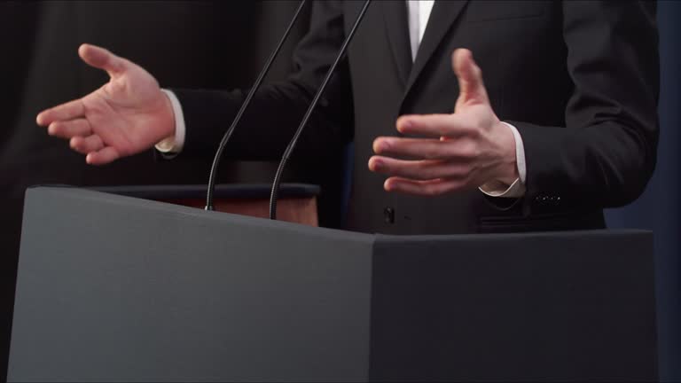 Close up of a politicians hands gesturing during a speech at the debates