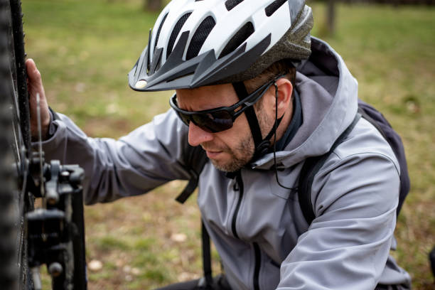 istock Man fixing mountain bike on trail 1385114287