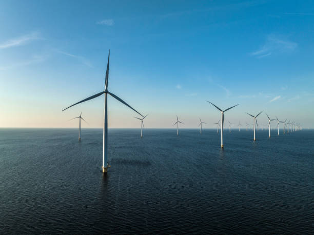 istock Wind turbines in an offshore wind park producing electricity 1385114452