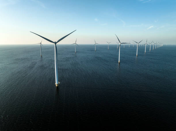 istock Wind turbines in an offshore wind park producing electricity 1385114605
