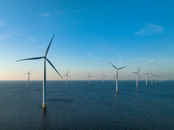 istock Wind turbines in an offshore wind park producing electricity 1385114725