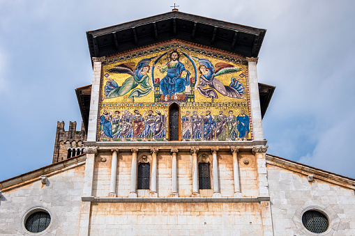 Monumental golden mosaic on the façade of the Basilica of San Frediano in Lucca, a Romanesque church completed in the 12th century