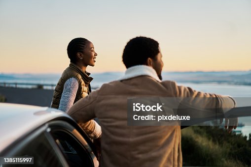 istock Shot of a young couple admiring the view on a road trip 1385115997