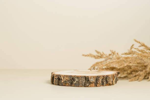 istock Wooden empty display with dry beige grass at the background, 1385117416