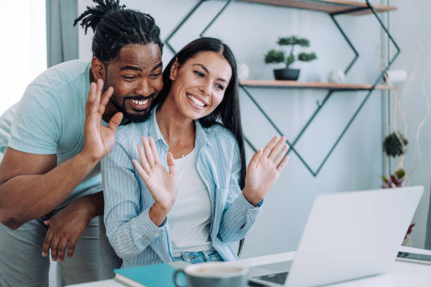 istock Cheerful couple having video call at home. 1385117896
