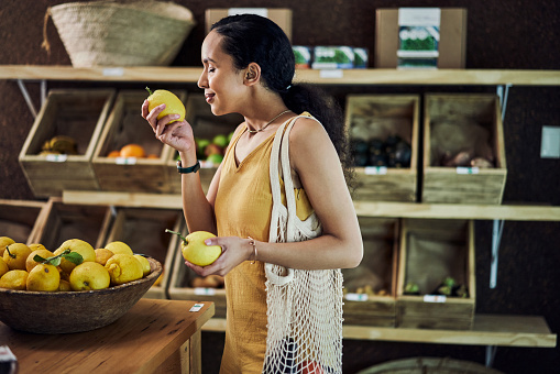 istock Shot of a young woman shopping in an organic store 1385118580