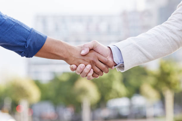 istock Shot of two unrecognizable businesspeople shaking hands 1385119325