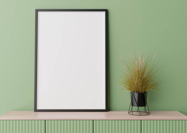 istock Empty vertical picture frame on green wall in modern living room. Mock up interior in contemporary style. Free space for picture, poster. Console, plant. 3D rendering. 1385119641