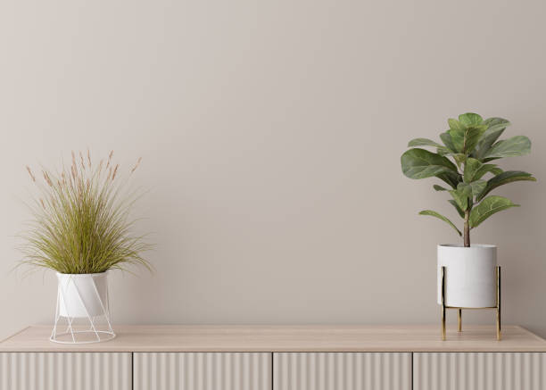istock Empty cream wall. Mock up interior in contemporary style. Close up view. Free, copy space for your picture, text, or another design. Sideboard, plants. 3D rendering. 1385119647