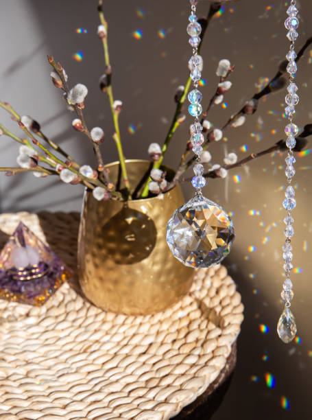 istock Selective focus on round ball shape crystal rainbow maker suncatcher hanging in home with Orgonite or Orgone pyramid. Good Feng Shui, Sha Chi reflection, energy flow concept. 1385120509