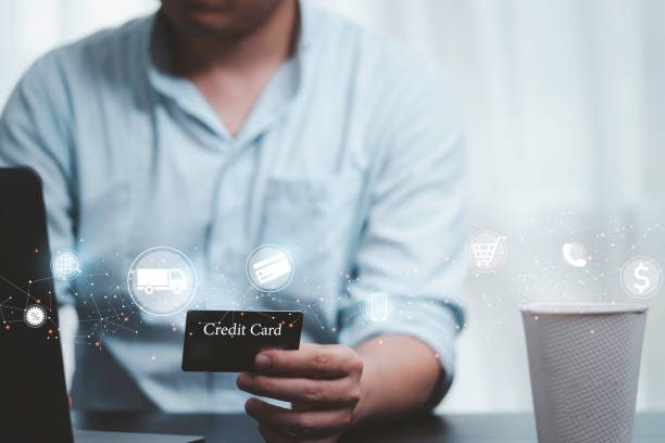 istock Shopper holding credit card and input shopping order by use computer laptop with online shopping and e-commerce icon concept. 1385120619