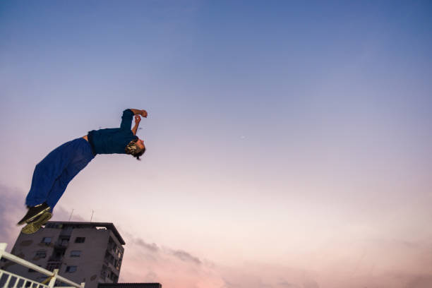 Man trains parkour while jumping in the air and doing tricks