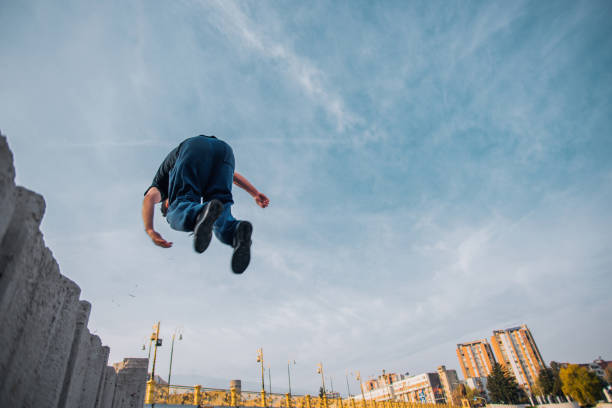 istock Caucasian man jump high in the air while doing parkour 1385123134