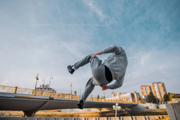 istock Young man doing parkour jump in the nature 1385123138
