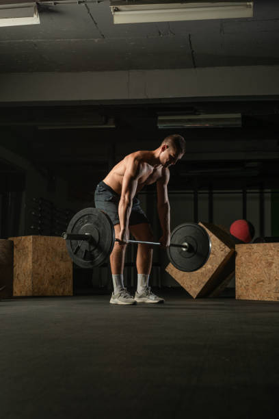 istock Fit strong shirtless athlete doing squats. Hardcore gym workout concept. 1385123365