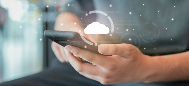 istock close up customer man hand hold smartphone to use transfer or synch data upload and download from cloud computing with virtual interface for technology business concept 1385123479