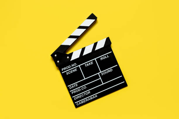 istock clapperboard for shooting video footage takes on a yellow background 1385123486