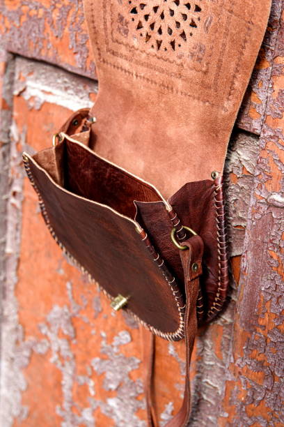 istock small brown women's leather bag with a carved pattern. selective focus 1385123489