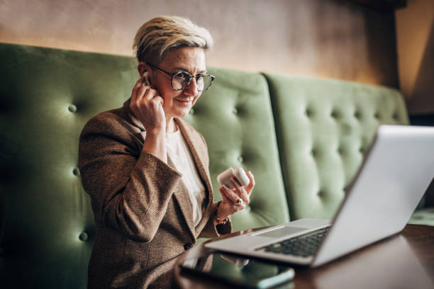 istock Woman using laptop in cafe 1385124941