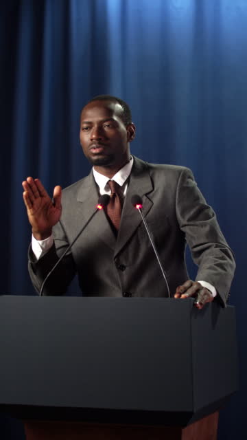 Young African speaker on a blue background