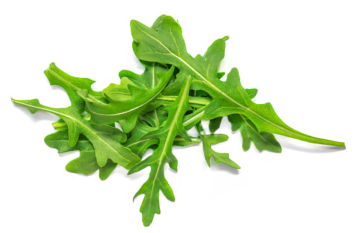 Fresh green arugula leaves isolated on white background, top view, flat lay. Pile of ruccola