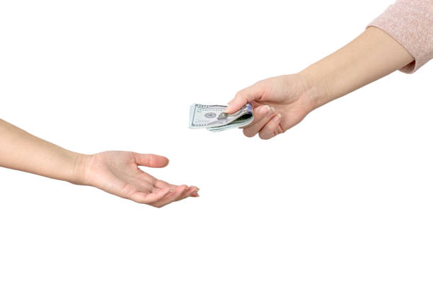 Close-up of a woman's hand holding a stack of paper bills in her palm