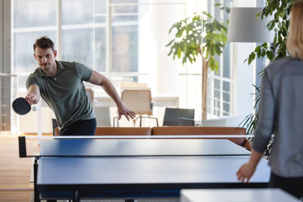 istock Two colleagues playing a table tennis game 1385138510
