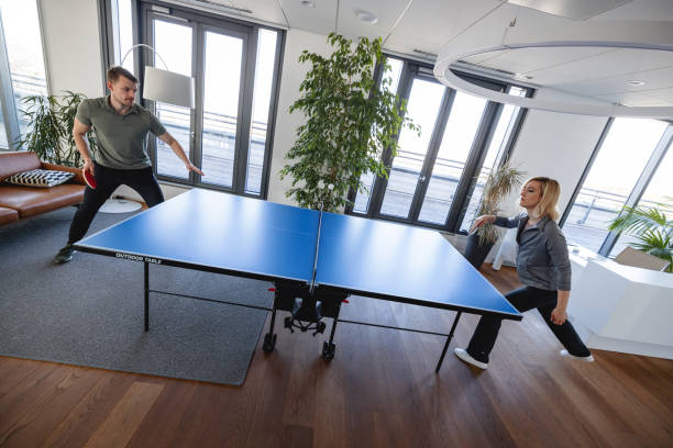istock Two business professionals playing table tennis in the office 1385138516