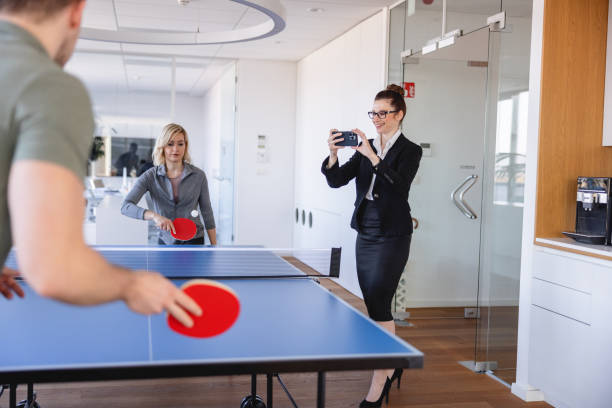 istock Caucasian White Collar Worker Recording While Her Colleagues are Playing 1385139521