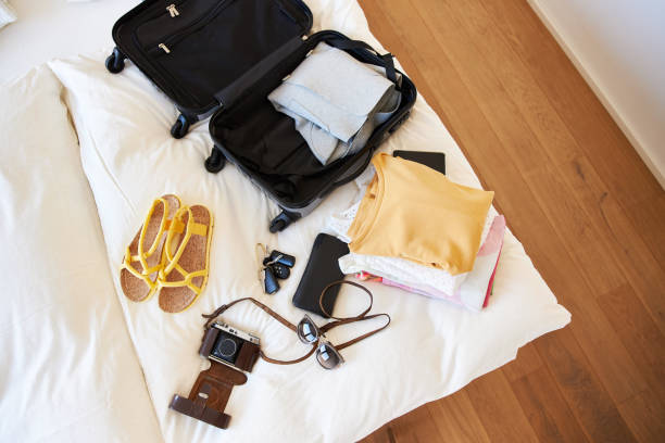 istock Several items and clothes for a city trip lie next to a suitcase, high res with copy space 1385139524