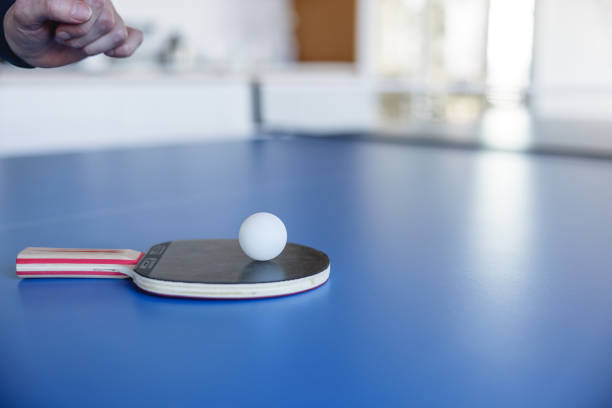 Ping pong racket with the ball for playing table tennis on a colored background