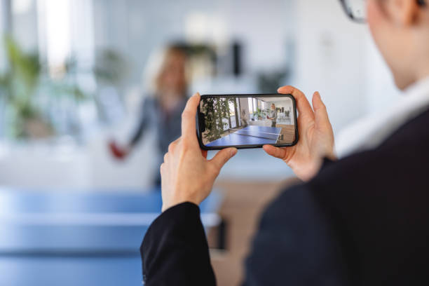 istock Office Worker Recording a Table Tennis Match Between Her Coworkers 1385139600