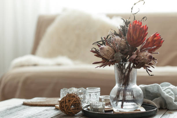 istock Cozy home composition with candles and protea bouquet. 1385139914