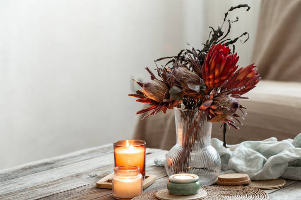 istock Cozy home composition with candles and protea bouquet. 1385139927