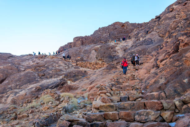 Many pilgrims go down from top of Mount Sinai (Moses Mount) in Egypt stock photo