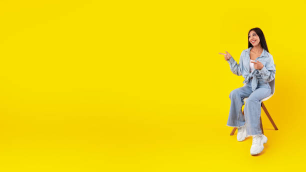 istock Excited woman pointing aside at free copy space 1385150983