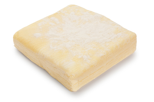 Studio shot of uncooked puff pastry cut out against a white background